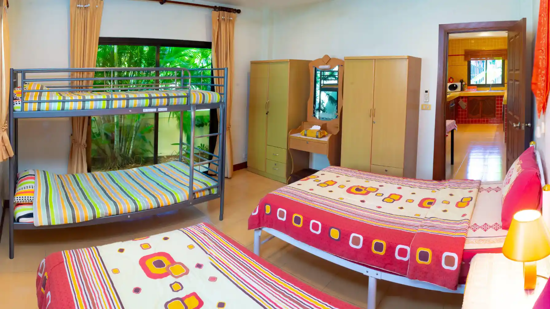 Bon Island Villa second bedroom with patio doors opening to tropical garden