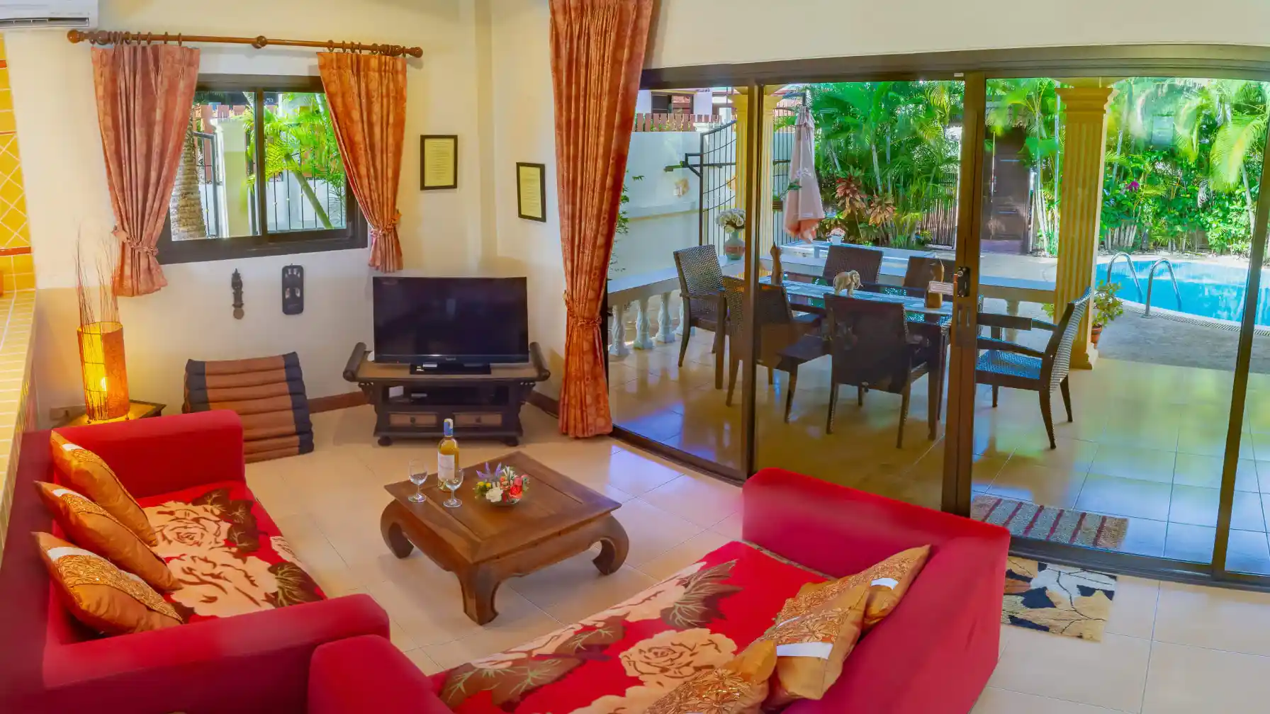 Bon Island Villa living room with vibrant red sofas and Smart TV