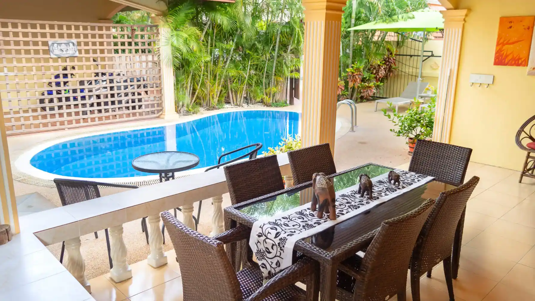 Coral Island Villa alfresco dining patio with tropical garden and pool