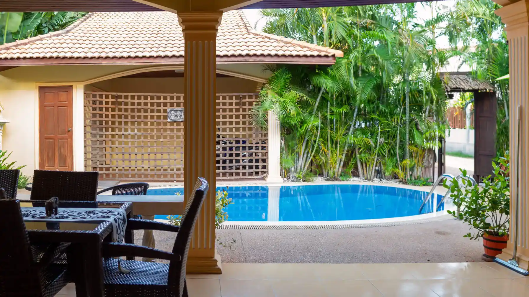 Coral Island Villa pool viewed from the covered outdoor dining patio